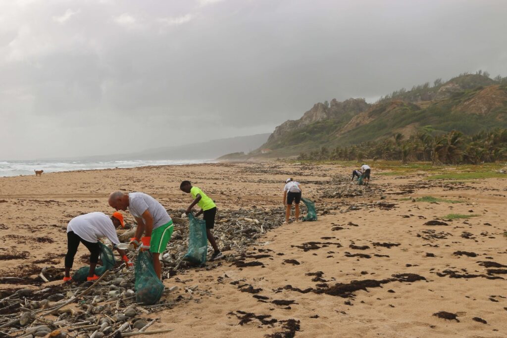 Volunteer cleaning up a beach
