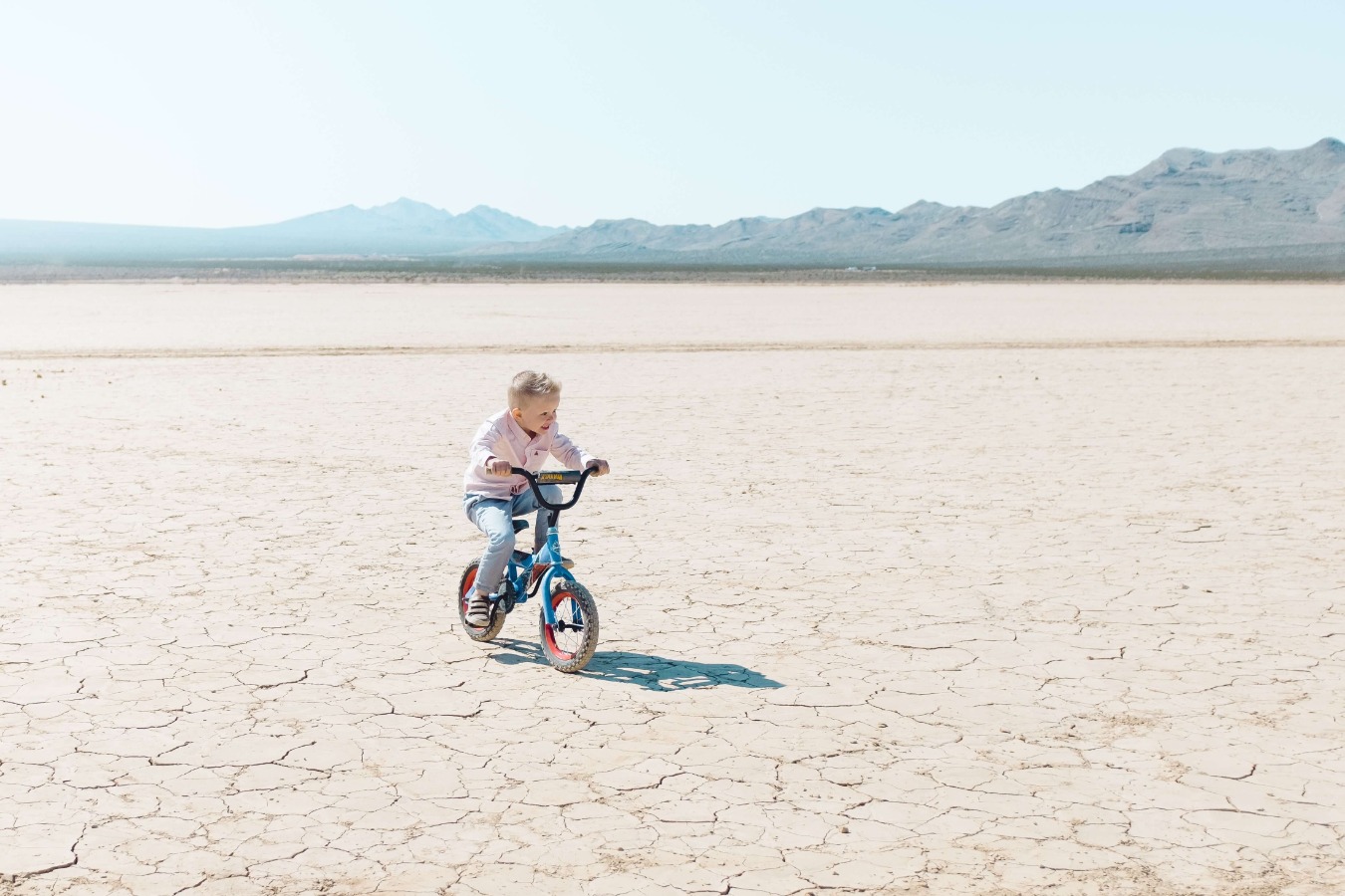 Kid riding bike in the desert
